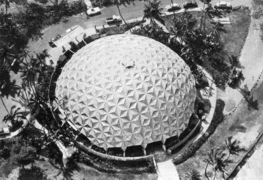 Figure 76: Kaiser 145-foot geodesic dome, manufactured in Oakland, California, and erected in 22 hours in Honolulu, Hawaii. At the 22nd hour, the Hawaiian Symphony Orchestra entered; the concert was completed withing 24 hours of the Honolulu landing of the dome’s components. The orchestra conductor pronounced the acoustics as “the best is his experience”. (Estate of R. B. Fuller.)